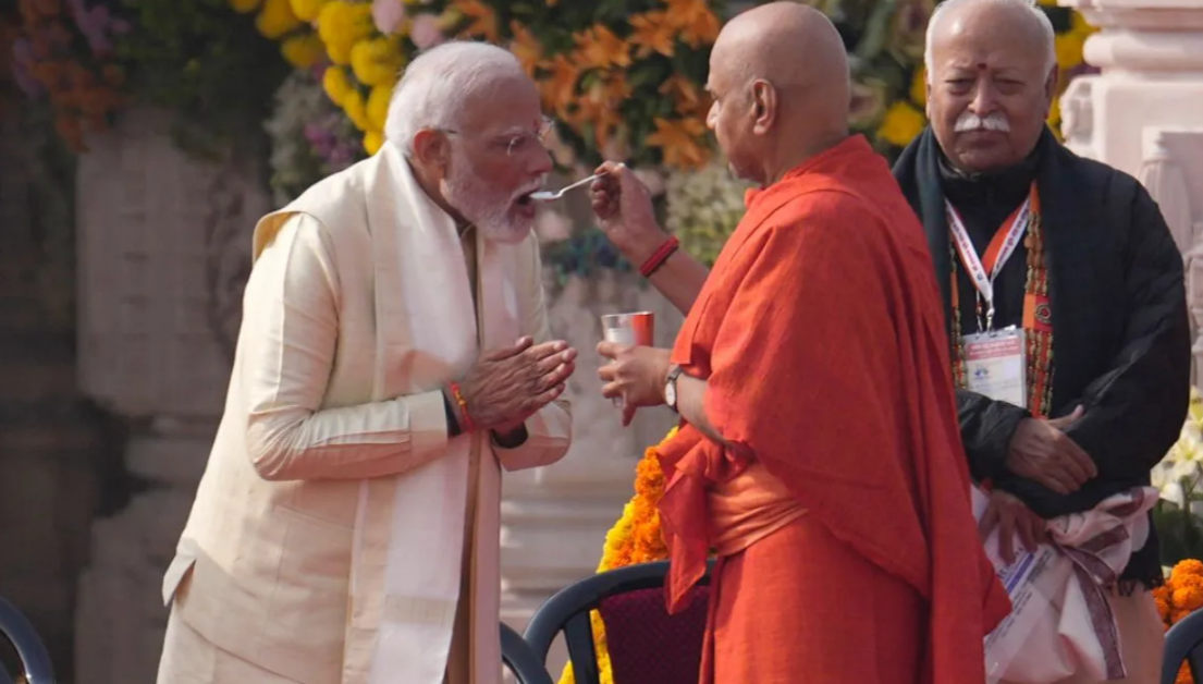 Narendra Modi drinking charanamrit from a spoon